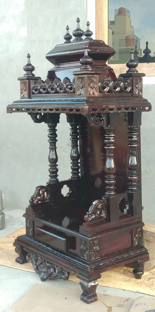 Side view of the dark-polished mantapa, with turned pillars and a scalloped eave