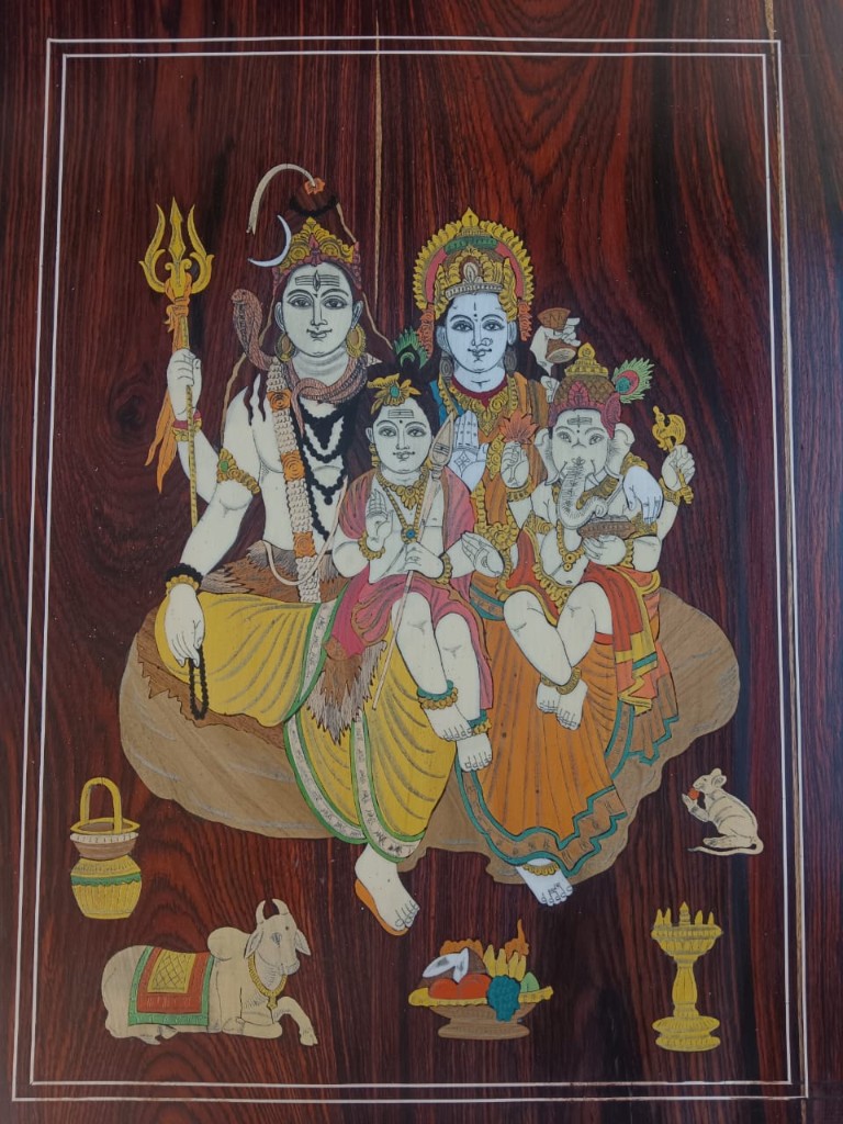 Close view of the painted Shiva Parivar panel on rosewood