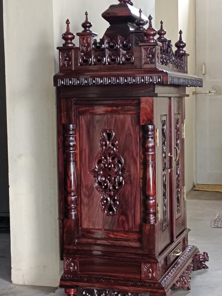 Side of the vine cabinet, with a floral panel and the pierced doors beyond